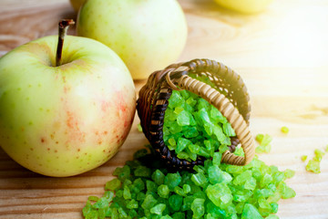 Green salt for aromatherapy . Sea bath salt with apple extract in a basket . 