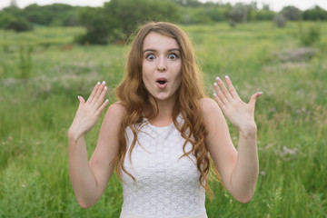 Beautiful young girl shows joy in nature