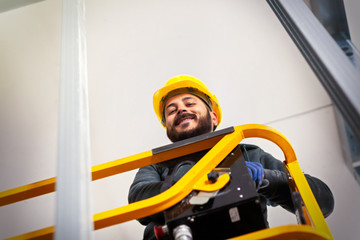 Fototapeta premium Worker builds a plasterboard wall.