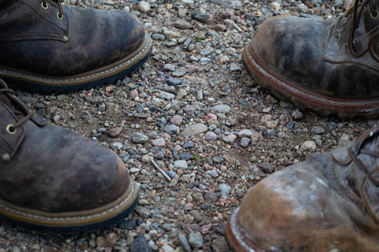 Close Up Of Work Boots Opposite Each Other On A Job Site