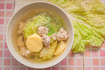 Clear soup with vegetables and meatballs.
