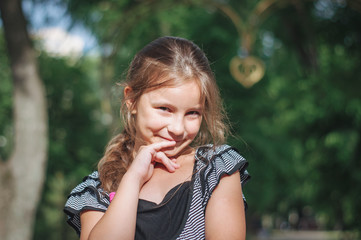 Fototapeta premium Little cute girl street city lifestyle shooting, summer, smiling at camera