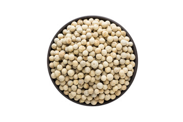 white pepper in clay bowl isolated on white background. Seasoning or spice top view