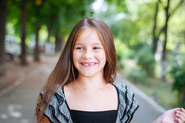 Little cute girl street city lifestyle shooting, summer, smiling at camera