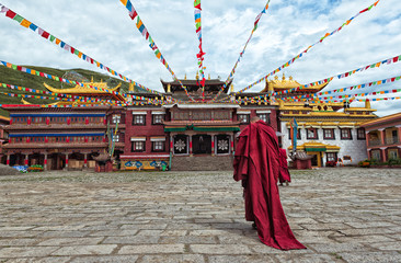 a lama praying before the temple in Tibet © Lawrence.W