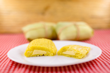 Fototapeta na wymiar Pamonha, Brazilian sweet corn with cheese filling. Pamonha typical of Brazil, food of the state of minas gerais and goiais. Concept of traditional food. Brazilian food