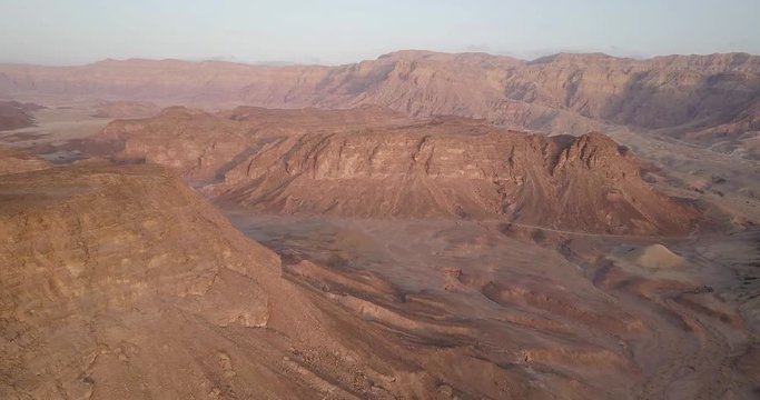 Flying over rocky desert mountains  Aerial view of Rocky Desert Mountains in Sasgon Timna Valley, Negev, Arava, Israel
