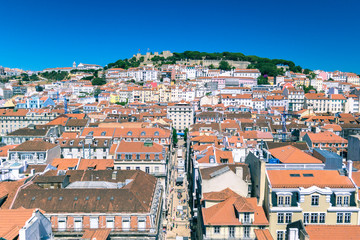 Red tiles and rooftops kissed by the sun above Lisbon.