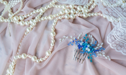 Wedding background with pearls and hair accessories on pink background