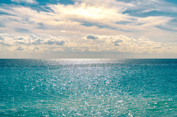 View of the Mediterranean Sea with the sun glistening on the horizon, at Nice, France