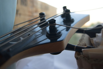 Bass guitar lying in front of the window in the early morning.