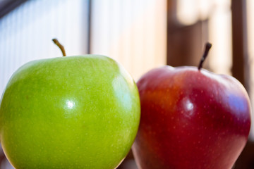  Two green and red apples close up. Delicious and nutritious fruits for breakfast and salads.