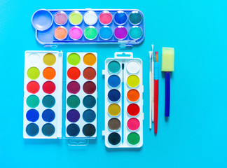 Stationery flat lay.Paints and brushes for creativity. Back to school.