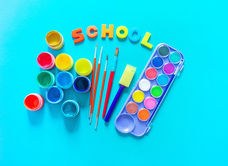 Stationery flat lay.Paints and brushes for creativity. Back to school.