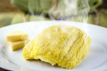 pamonha, Brazilian sweet made from homemade cheese with corn. Open pissing ready for consumption. Concept of traditional Brazilian sweet, typical food of the months of June and July.