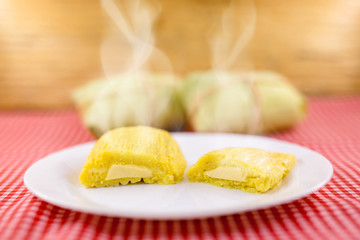 Pamonha, Brazilian sweet corn with cheese filling. Pamonha typical of Brazil, food of the state of minas gerais. Concept of traditional food. Brazilian food at rural parties in June and July.