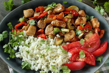 carb free lunch keto diet. fried chicken breast with vegetables and cauliflower rice. keto recipe