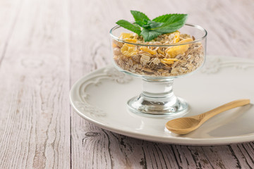 Oatmeal and muesli in a bowl on a wooden table. Food rich in fiber.
