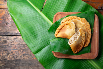 Easter Island Tuna empanadas on banana palm tree leaves. Top view