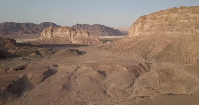 Flying over rocky desert mountains  Aerial view of Rocky Desert Mountains in Sasgon Timna Valley, Negev, Arava, Israel