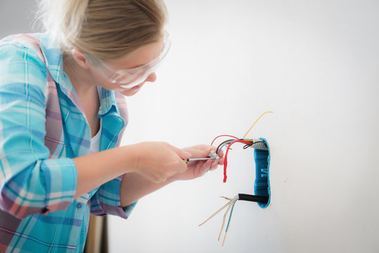 Woman Electrician Work At House. Professional Worker