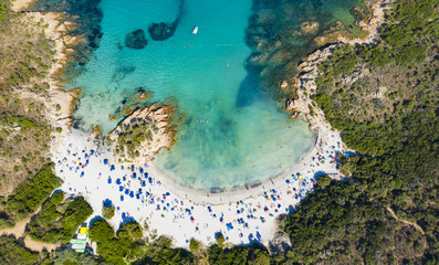 View from above, stunning aerial view of a beautiful beach bathed by a turquoise clear sea. Spiaggia del Principe, (Emerald Coast) Sardinia, Italy.