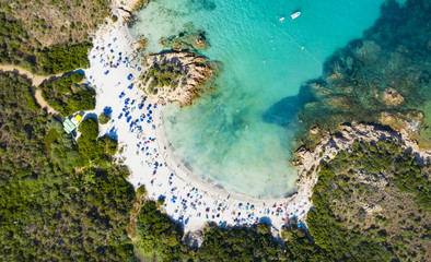 View from above, stunning aerial view of a beautiful beach bathed by a turquoise clear sea. Spiaggia del Principe, (Emerald Coast) Sardinia, Italy.