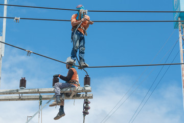 Electricians repairing,electricians repairing wire on electric power pole, power linesman climb the...