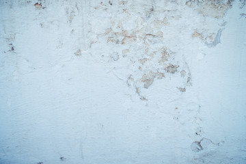 The walls of the wall paint peel off because of the long age and moisture on the wall, Surface of a textured wall with patches and cracks, background, cracked concrete vintage wall background.