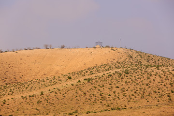 Large chanukiah on hill in desert under blue sky