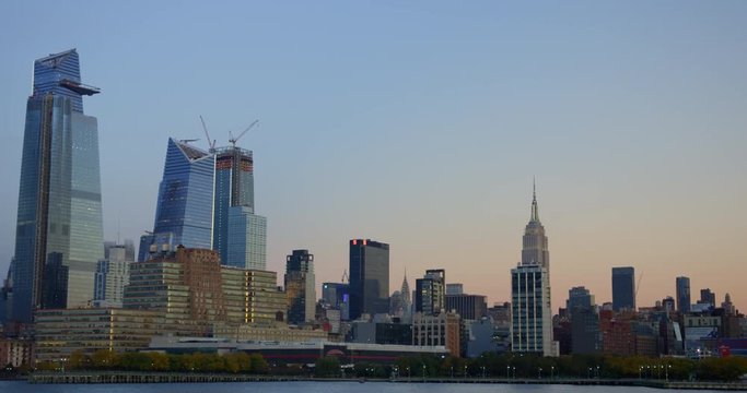 Impressive New York Skyline At Evening With The Iconic Empire State Building On Beautiful Hudson River In Iconic NYC