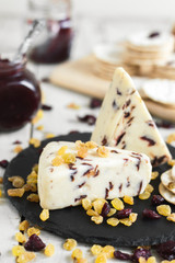 Cranberry cheese with raisin and dried cranberry on a slate board