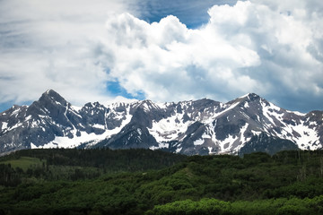Fototapeta na wymiar Snow covered peaks near Mount Wilson in July - Colorado