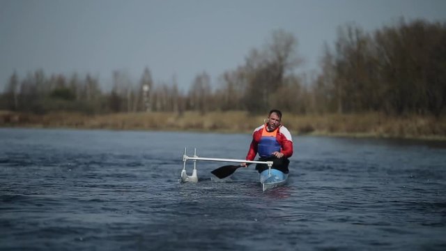 Disabled athlete rowing on the river in a canoe. Rowing, canoeing, paddling. Training. Kayaking. paraolympic sport. canoe for disabled people.