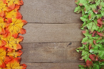 Naklejka na ściany i meble Autumn Maple leave border frame on wooden background