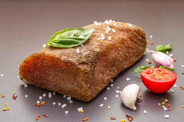 Raw pork loin with vegetables, species and herbs