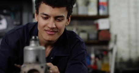 4K Close up portrait smiling mixed race mechanic in garage workshop