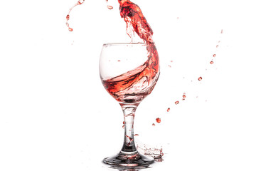 Red wine splash in a round glass on a white background