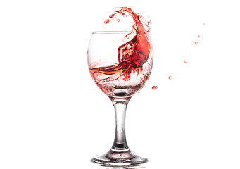 Red wine splash in a round glass on a white background