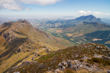 View out over the Cape Winelands in South Africa, from a high mountain ridge on a summer day.