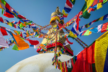 The Buddhist stupa of Boudha Stupa, Kathmandu, Nepal. Prayers flags in all the colors are attached...