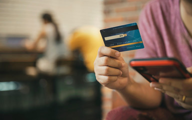 Shopping online payment with credit card , woman using mobile smartphone ,  business e-commerce and application concept