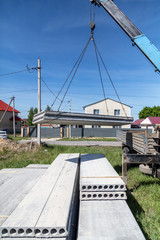 A crane raised a concrete slab at a construction site at home
