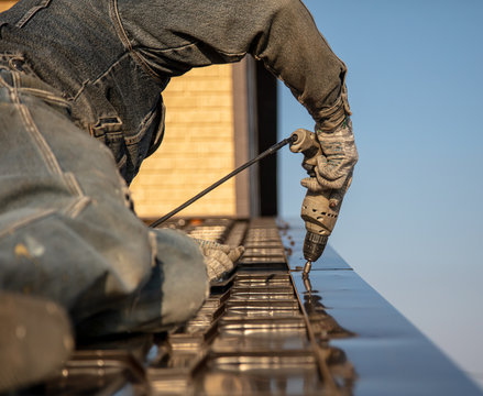 Installation of metal tiles on the roof of the house