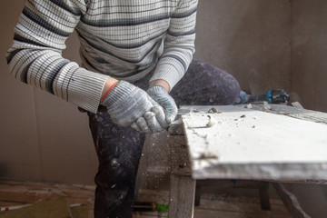 Worker cuts with a knife drywall repair