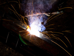 Sparks from welding at a construction site as a background