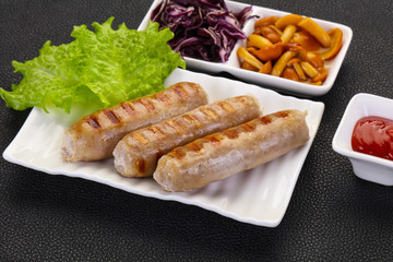 Grilled sausages served mushrooms and cabbage