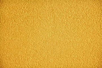 Gold cement wall abstract texture in seamless rough patterns for yellow colorful background