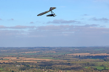 Fototapeta na wymiar Hang glider flying at Combe Gibbet