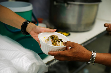 Food sharing in human societies can help homeless people : concept Sharing Food With Homeless